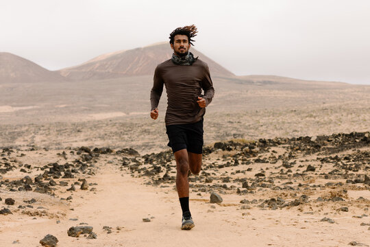 A trekker exercises by jogging on a rocky trail