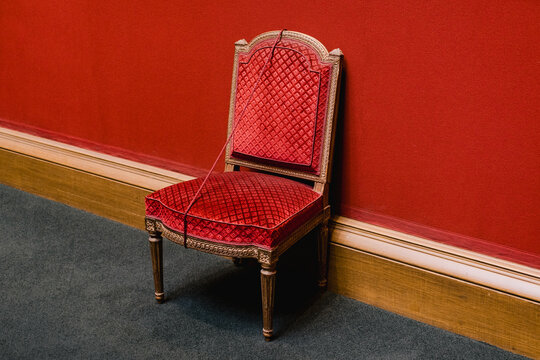 A red chair against a red wall