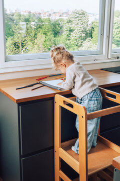 dowing homework on kitchen tower
