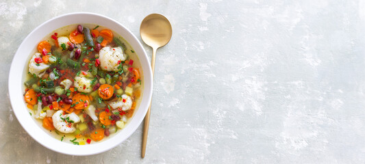 Vegetable soup with cauliflower, beans, carrots and zucchini. Healthy eating. Vegetarian food.