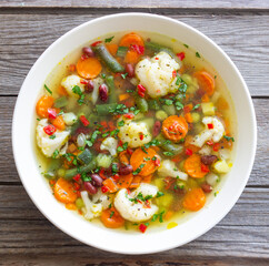 Vegetable soup with cauliflower, beans, carrots and zucchini. Healthy eating. Vegetarian food.