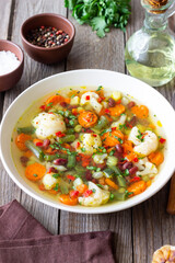 Vegetable soup with cauliflower, beans, carrots and zucchini. Healthy eating. Vegetarian food.