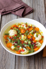 Vegetable soup with cauliflower, beans, carrots and zucchini. Healthy eating. Vegetarian food.