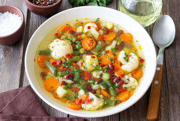 Vegetable soup with cauliflower, beans, carrots and zucchini. Healthy eating. Vegetarian food.