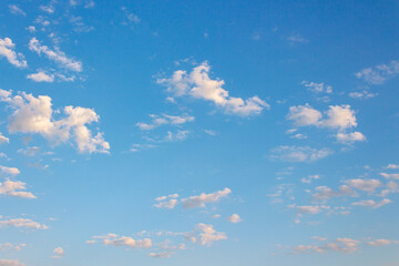 blue sky with clouds on a sunny august morning. fluffy formations in bright weather. blue nature...