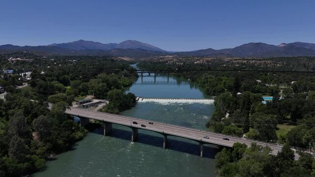 Aerial 4K Drone Video of Cars Driving Over Bridge Crossing the Sacramento River in Redding, California