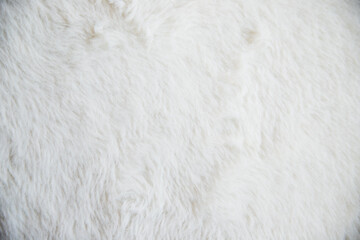 Close-up of white faux fur showing a soft, fluffy texture. The concept of fabric and textile...