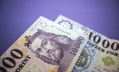 Hungarian forint banknotes with purple background.
