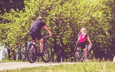 Cyclists ride on the bike path in the city Park
