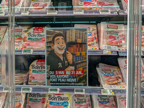 France, 25 April 2025 : Cartoon man shaving face in front of deli meat section, supermarket
