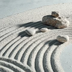  Zen garden with light beige sand and rocks © Yusnira