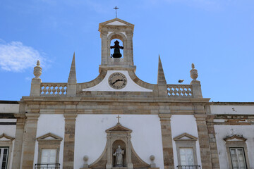 Facade with bell and clock from the Arco da Vila in Faro, Portugal  