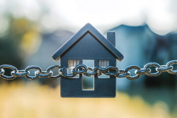 House model bound by a metal chain outdoors