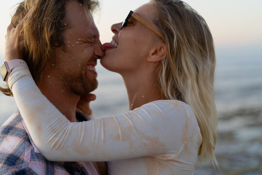 Playful couple laughing and teasing at the beach