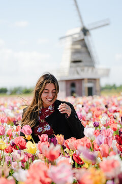 Dutch Tulip Field with Woman Smiling Amid Rows of Flowers