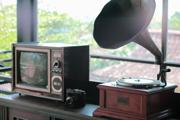 Perfect illustration for retro background style, with old tv, retro camera, gramophone on a desk beside old bycicle.