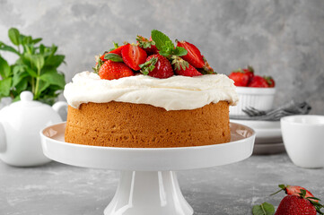 Vanilla sponge cake with whipped cream and fresh strawberries. Summer cake. Selective focus