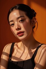 Dermatology-focused stock photo female with flawless skin poses in casual tanktop warm studio lighting commercial use
