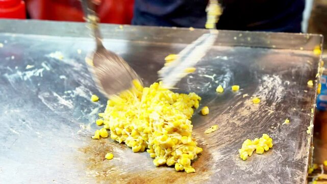 Jagung keju tarik (pulled cheese corn). Steam corn mixed with cheese. Indonesian modern street food.