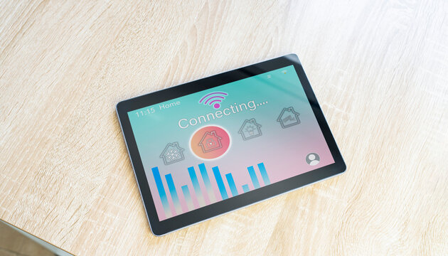 Digital tablet with house and wifi icon on table