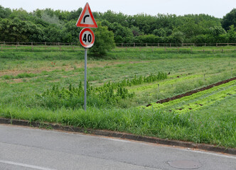 bend to right and speed limit sign
