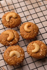 sesame and cashew cookies on a cooling rack.