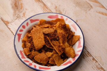 Crispy egg rendang on a plate. Indonesian food originating from West Sumatra. Rending telur.