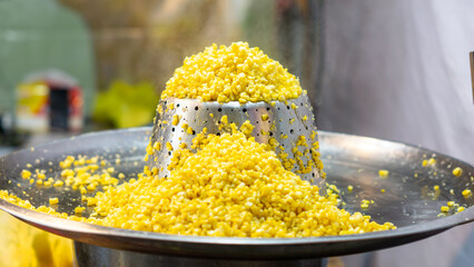 Jagung keju tarik (pulled cheese corn). Steam corn mixed with cheese. Indonesian modern street food.