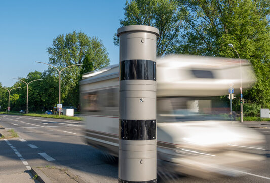 Modern speed camera monitoring a camper van with motion blur in Augsburg, Bavaria