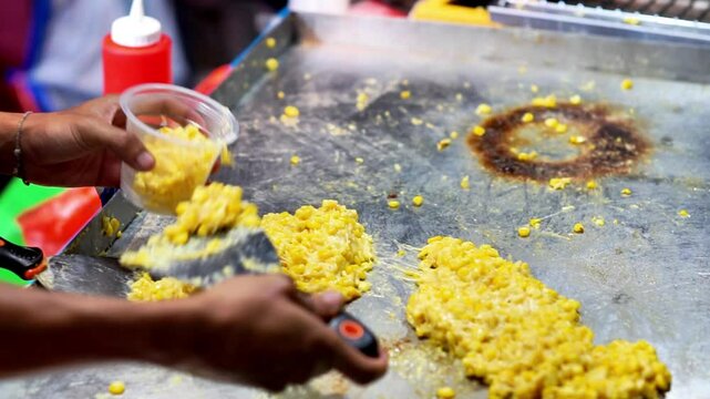 Jagung keju tarik (pulled cheese corn). Steam corn mixed with cheese. Indonesian modern street food.