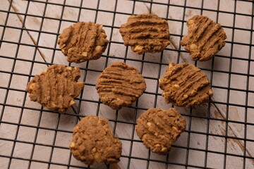 sesame, oat, peanut cookies with spice flavor on cooling rack. healthy food.