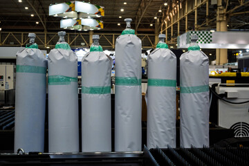 Industrial gas cylinders wrapped in protective covers, showcased at a trade show for safety and...