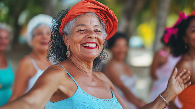 A diverse group of old older or senior women are having fun together and dancing in sunshine on vacation, age positivity, wide landscape horizontal 16:9