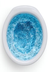 Overhead view of a small, oval, white spa tub filled with light blue water