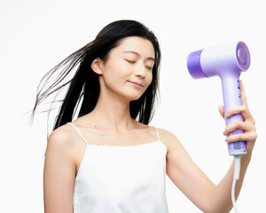 Asian girl using hair dryer