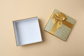 Open gift box on color background, top view