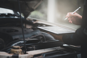Car Engine Service Concept, Car Mechanic Writing Checklist on Digital Tablet for Machinery Repair, Car Service and Maintenance