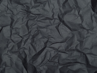 Texture of crumpled dark gray paper. Background