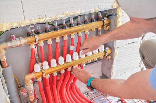 The image showcases a modern plumbing installation featuring red piping, valves, and fittings, illustrating the intricacies of plumbing work and craftsmanship
