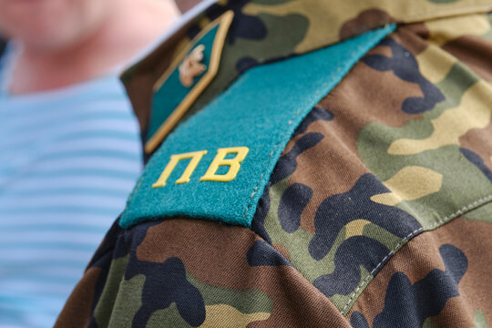 Close-up of shoulder strap of Border Troops of Russia Federation on shoulder of border guard