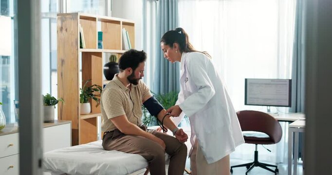 Blood pressure, consultation and doctor with man in clinic for heart health, pulse or checkup. Sphygmomanometer, medical and physician with male patient for hypertension assessment in hospital.
