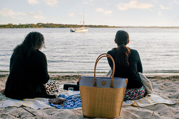 Young women on vacation in Biscaros enjoying the sunset