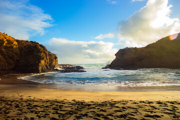 Beautiful lagoon and ocean beach in Piha, Auckland, New Zealand, before sunset.