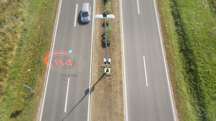 Aerial view of a traffic surveillance camera monitoring car speeds with a 3D graphic overlay...