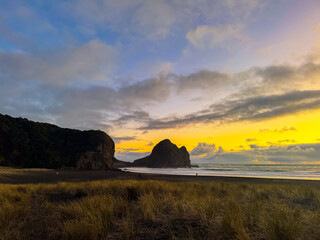 Beautiful lagoon and ocean beach in Piha, Auckland, New Zealand, before sunset.