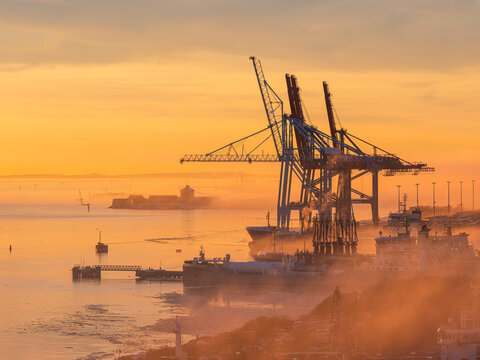 Construction site at harbor during golden hour