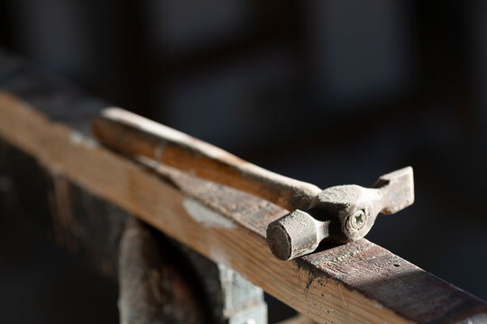 Sunlight shining on hammer kept on wood