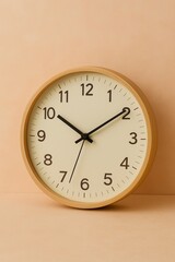 Minimalist wooden wall clock on cream background shows the time ticking.