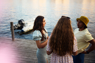 High angle view of friends spending leisure time talking with each other while standing on patio