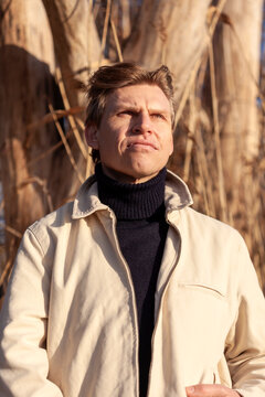 Contemplative mature man wearing turtleneck looking away